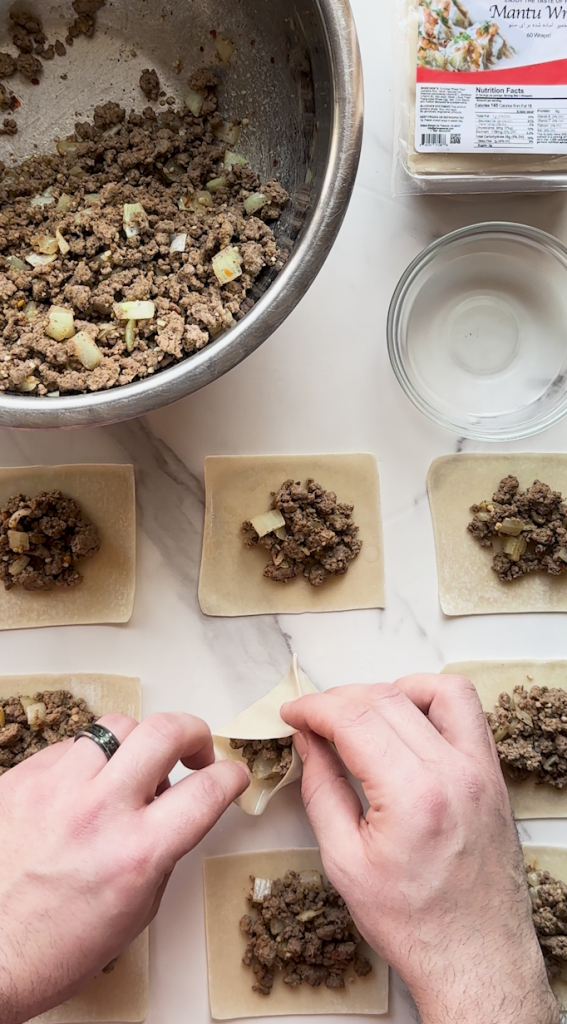 mantu being prepped with dumpling wraps from Ariana sweets